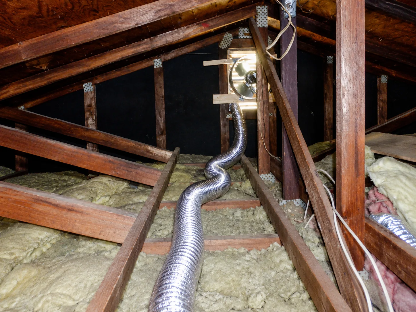 Long, sagging flexible bathroom fan duct found in an attic