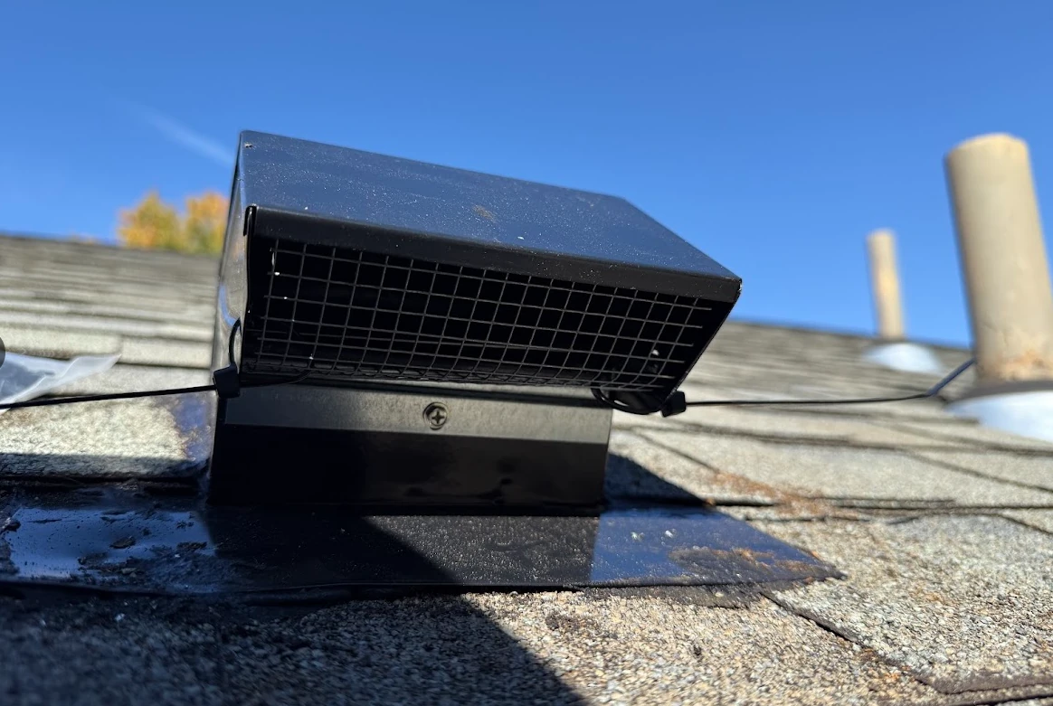 Bathroom exhaust duct connected to a roof cap termination