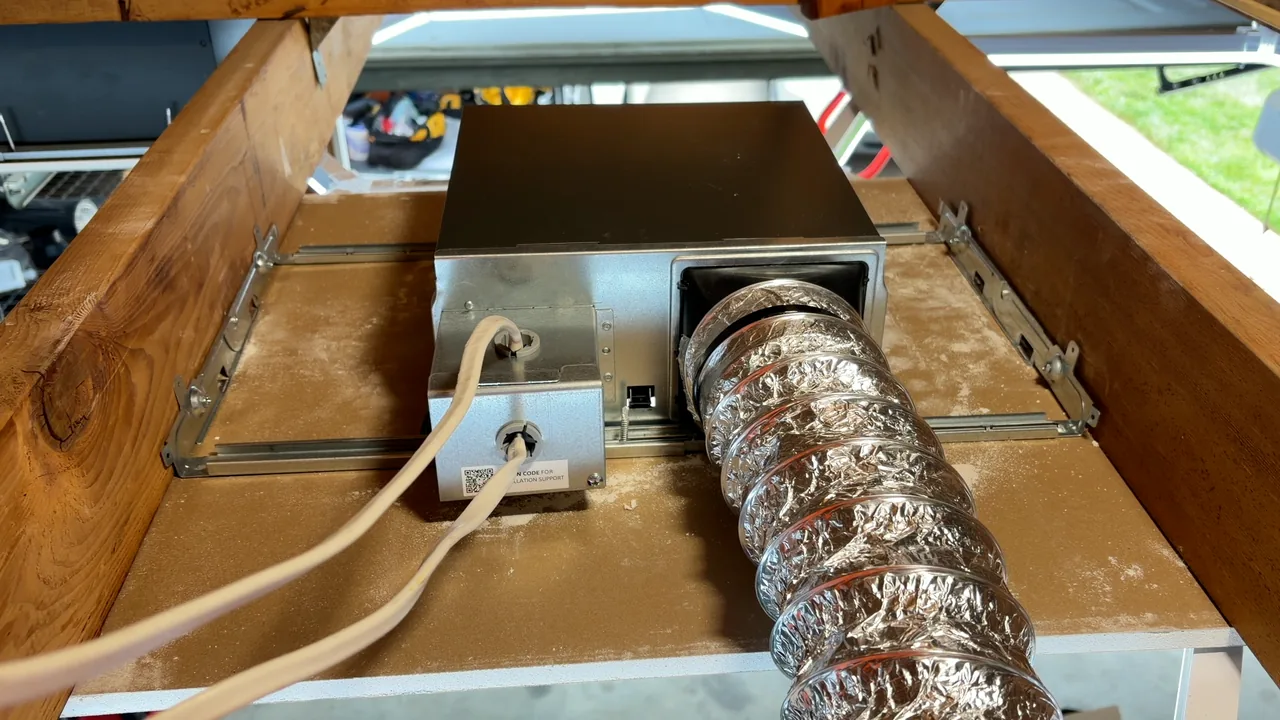Panasonic WhisperFit installed with bracket, duct, and electrical connections visible